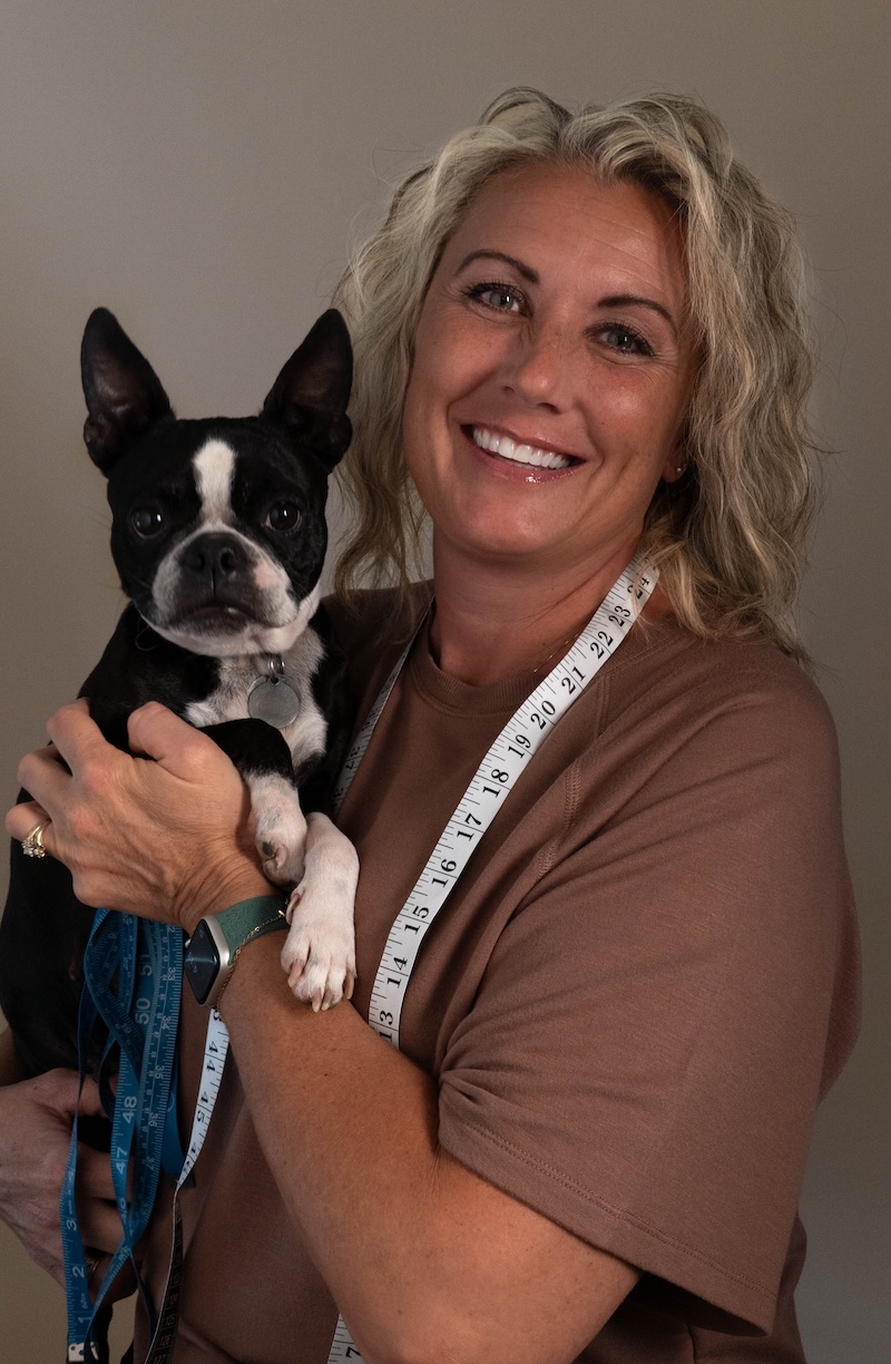 Sewn The Stitchery owner with measuring tape and dog